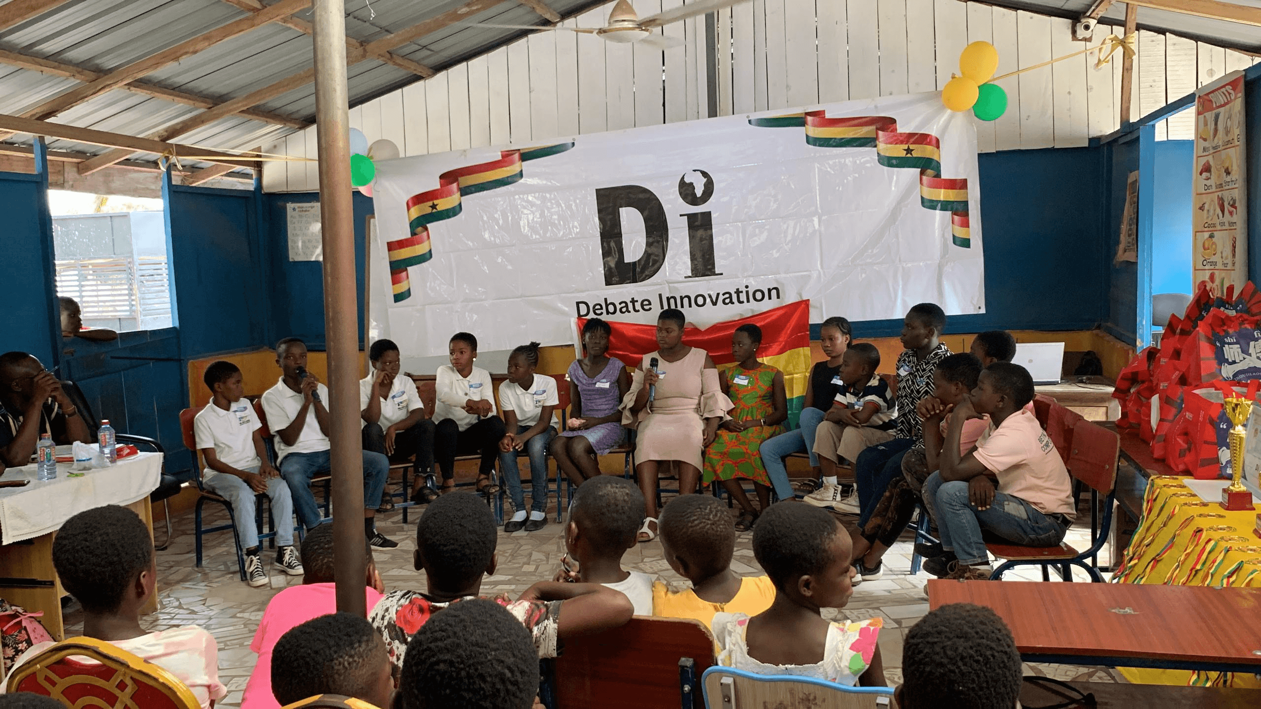 A student panel addressing a packed school hall